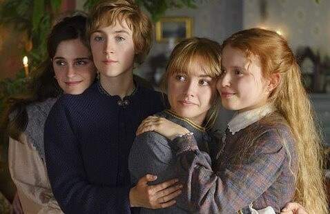 Film still from the 2019 Film adaptation of Little Women - The 4 March Sisters are smiling and hugging one another
